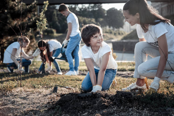 istock Cheerful nice woman looking at the boy 921332968