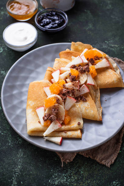 istock Pancakes crepes with different fruits and chocolate 921335148