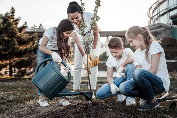 istock Nice positive girl caring about the tree 921335190