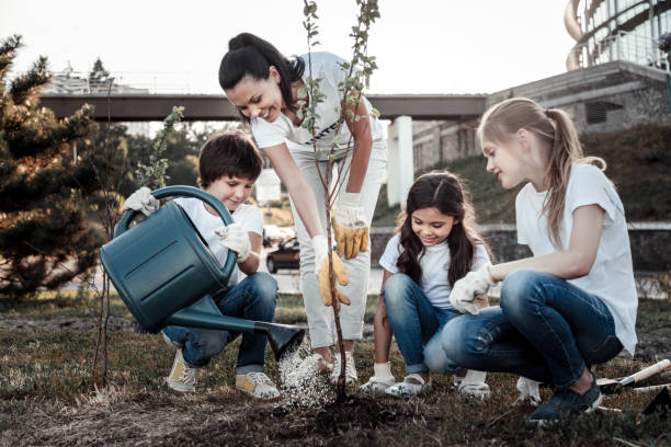 istock Cute positive boy holding a watering pot 921335216