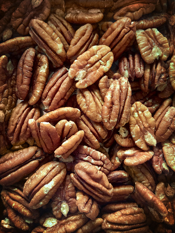 Lots of raw organic pecan nuts. Pecan background. Healthy delicious pecan nuts for energy and healthy living