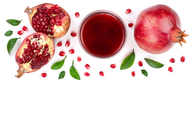 istock pomegranate juice with fresh pomegranate fruits isolated on white background with copy space for your text. Top view 921337996