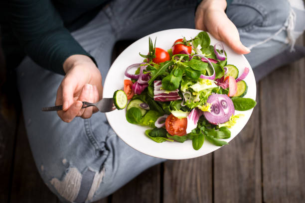 istock Fresh salad in hands view from above 921338546