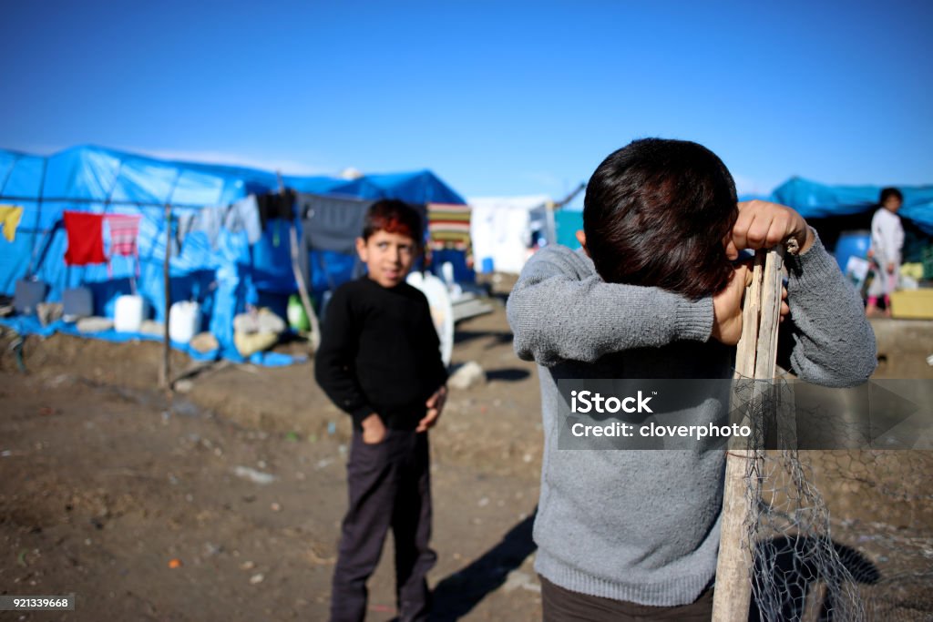 sad syrian little boy in refugee camp Sad child, Activity, Camping, Street, Syria Refugee Stock Photo