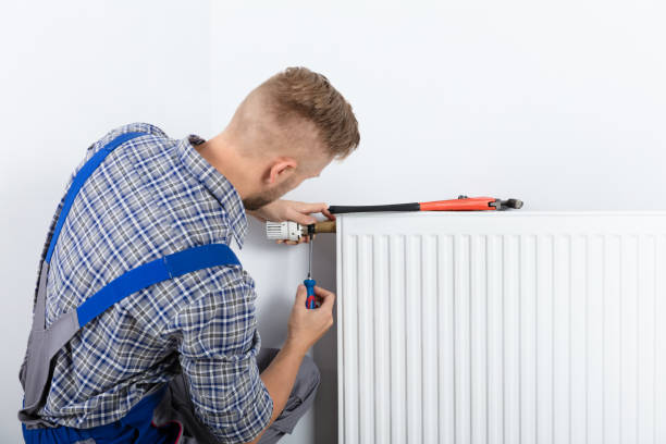 istock Male Plumber Fixing Thermostat 921342376