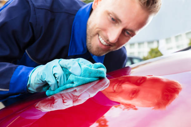 istock Happy Male Worker Cleaning Red Car 921342518