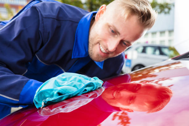 istock Happy Male Worker Cleaning Red Car 921342534