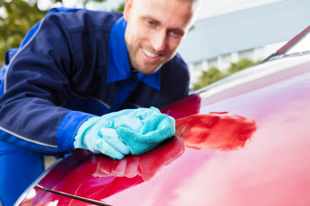 istock Happy Male Worker Cleaning Red Car 921342548