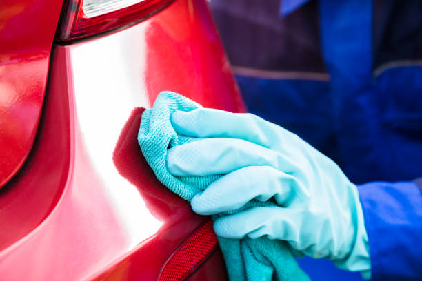 istock Happy Male Worker Cleaning Red Car 921342574