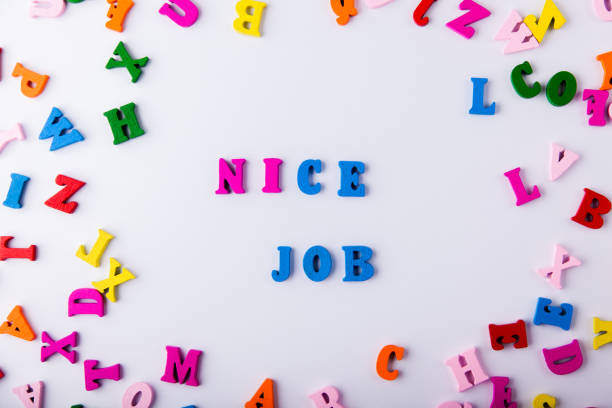 istock Nice job. Scattered colorful wooden letters 921345602