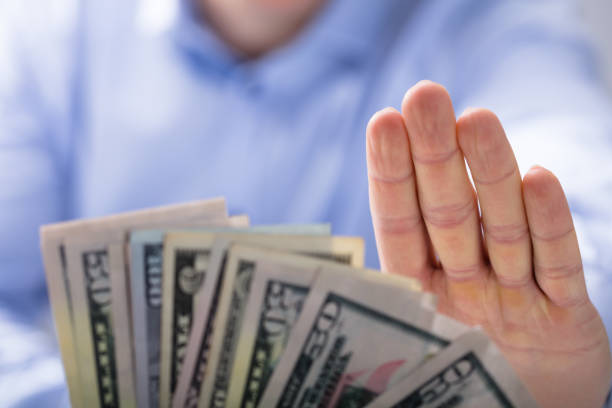 istock Man Rejecting An Offer Of Money 921345666
