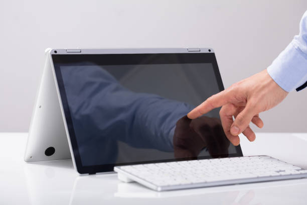 istock Businessman Touching His Finger On Hybrid Laptop Screen 921345714