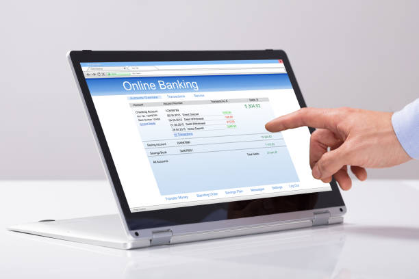 istock Male's Hand Using Online Banking On Hybrid Laptop 921345736