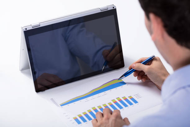 istock Businessman Analyzing The Graph On Hybrid Laptop 921345770
