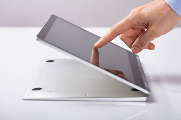 Cropped shot of a businessman using a digital tablet with a green screen during a meeting at work