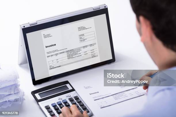 Businessman Calculating The Invoice Stock Photo - Download Image Now - Accountancy, Financial Bill, Writing - Activity