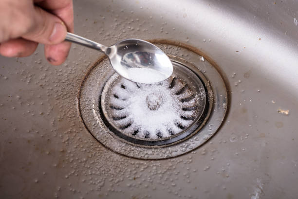 istock Person Cleaning The Washbasin Drain 921346118
