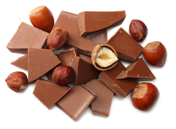 istock cracked chocolate candies sweets with nuts isolated on white background top view 921346558