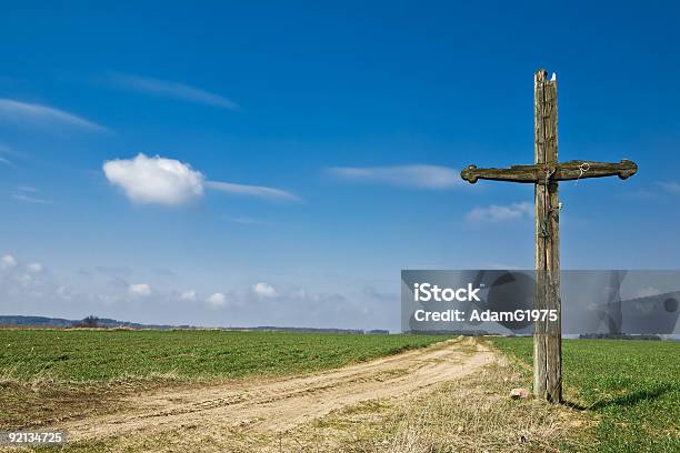 Old Cross Standing On The Side Of A Road Stock Photo - Download Image Now - Agricultural Field, Backgrounds, Blue