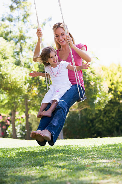 istock Mother and daughter on garden swing 92134780