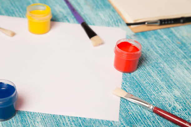 istock School supplies on a blue wooden background 921349400