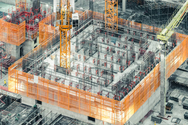 istock Isometric top view of an under construction building. Civil engineering, industrial development project, tower basement foundation infrastructure, or real estate property investment concept 921349868