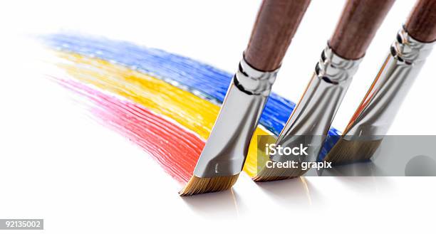 Closeup Of Three Painting Brushes Drawing Different Colors Stock Photo - Download Image Now