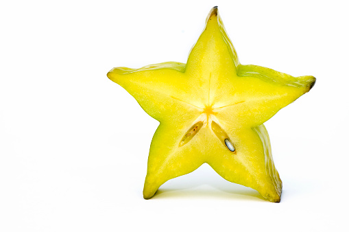 Yellow Star Fruit on White Background. Copy Space.