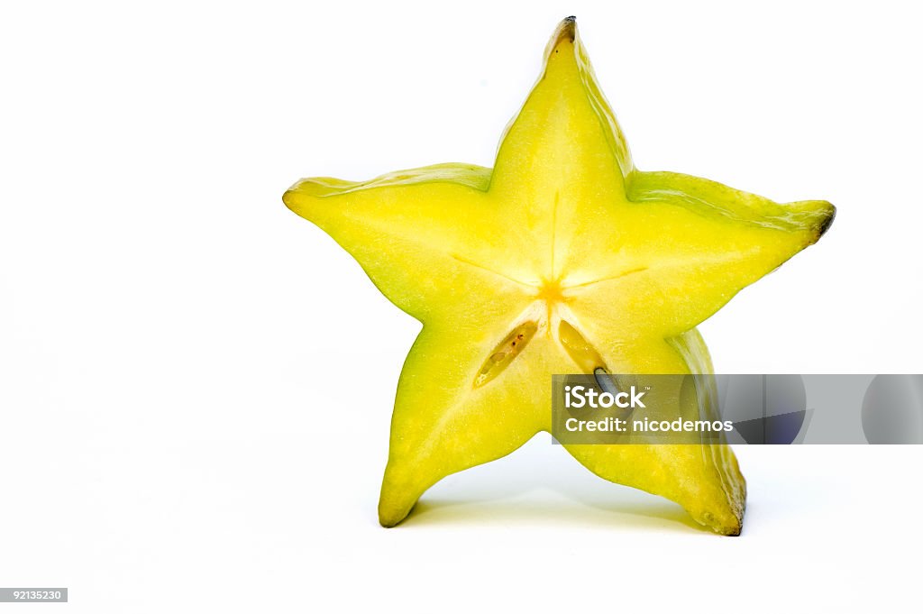 Five point Yellow star fruit standing up Yellow Star Fruit on White Background. Copy Space. Starfruit Stock Photo