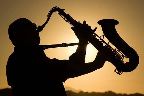 istock saxophonist at dusk 1 92135248
