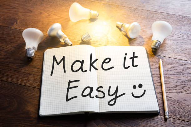 istock Notebook With Glowing Light Bulbs On Wooden Desk 921352870