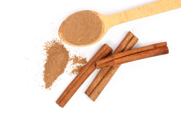istock Cinnamon sticks with powder isolated on white background. Top view 921353272