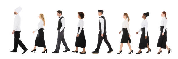 istock Young Restaurant Staff Walking In Row 921353632