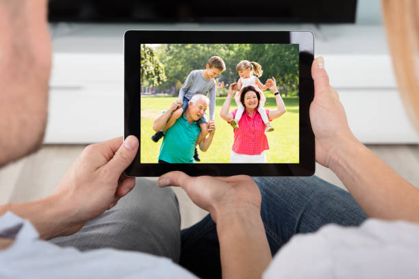 istock Couple Looking At House With Digital Tablet 921353710