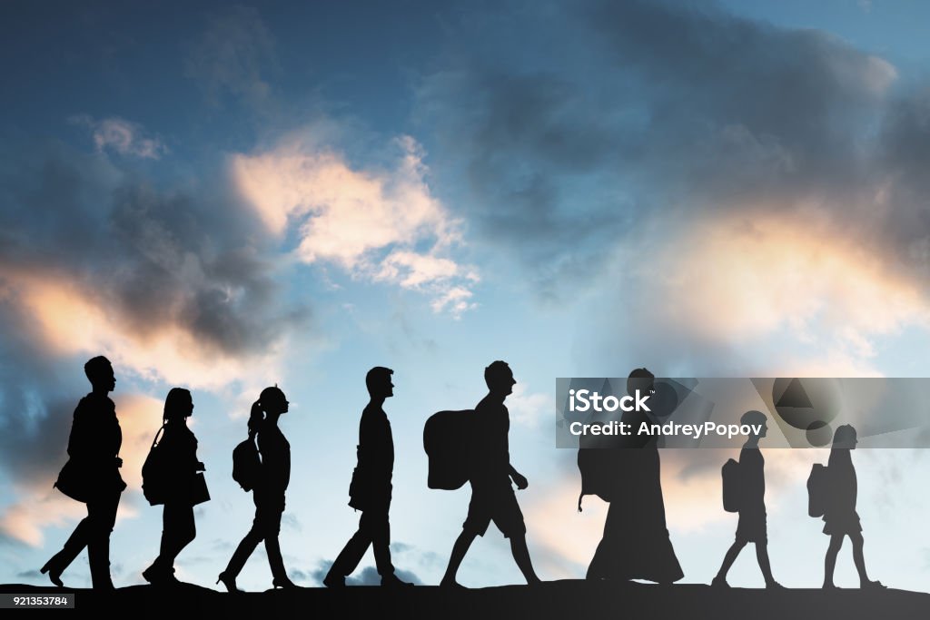 Refugees People With Luggage Walking In A Row Silhouette Of Refugees People With Luggage Walking In A Row Emigration and Immigration Stock Photo