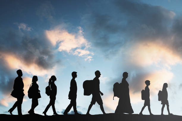 Refugees People With Luggage Walking In A Row Silhouette Of Refugees People With Luggage Walking In A Row emigration and immigration stock pictures, royalty-free photos & images