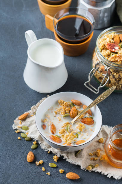 istock Breakfast with black coffee muesli granola honey nuts milk 921356202