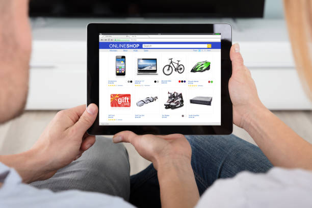 istock Couple Looking At House With Digital Tablet 921356354