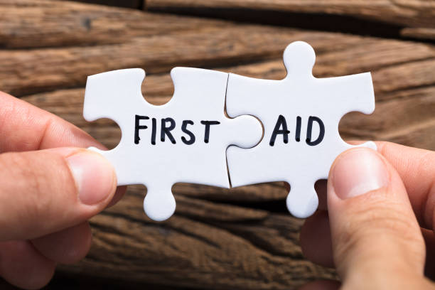 istock Closeup Of Hands Connecting First Aid Jigsaw Pieces 921356598