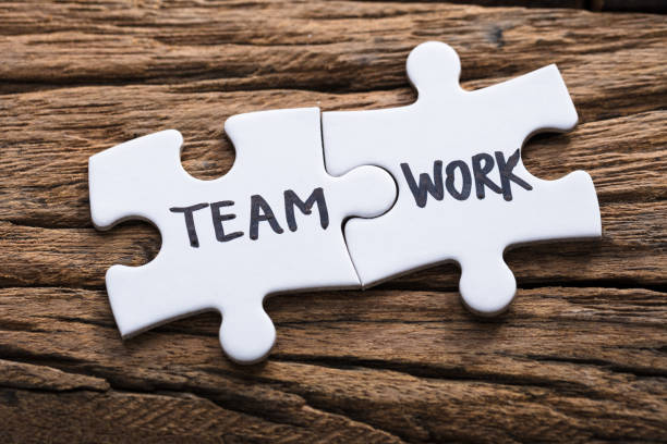 istock Closeup Of Connected Team Work Jigsaw Pieces 921356616