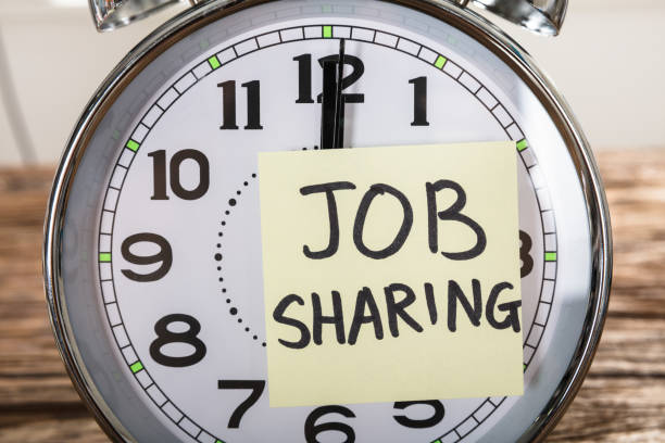 istock Job Sharing Adhesive Note Stuck On Alarm Clock 921356666