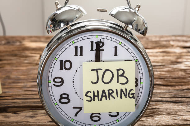 istock Job Sharing Adhesive Note Stuck On Alarm Clock 921356682