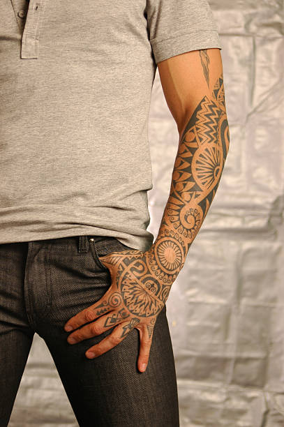 A man with a henna tattoo on his arm stock photo