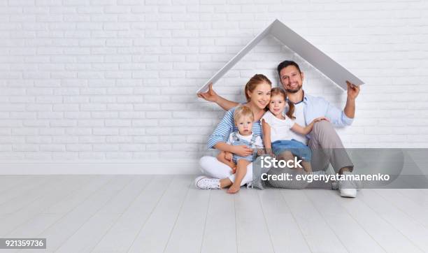 Concept Housing A Young Family Mother Father And Children In New Home Stock Photo - Download Image Now