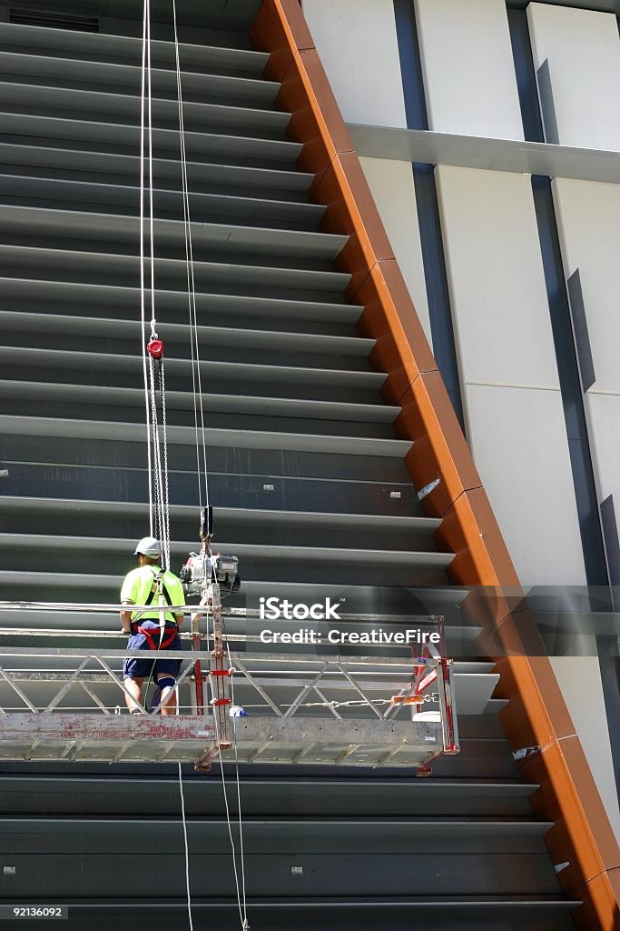 Scaffold Worker Scaffold worker on high rise gantry Blue-collar Worker Stock Photo