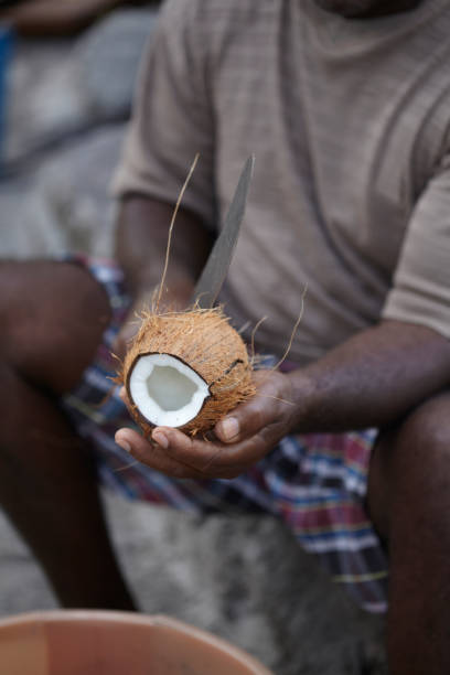 istock Afro Caribbean Man Shelling Coconut 921364564