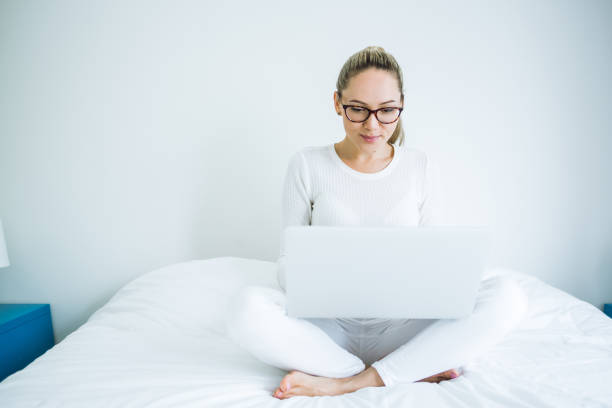 istock Beautiful young woman working with laptop 921364586