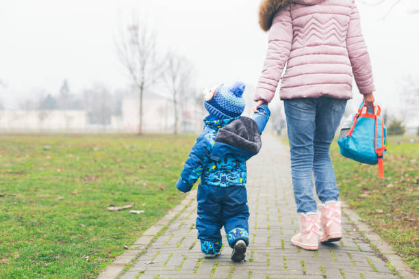istock Mother holding a hand of her son 921365006