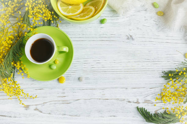 istock Mimosa, lemon and coffee on light background 921365020