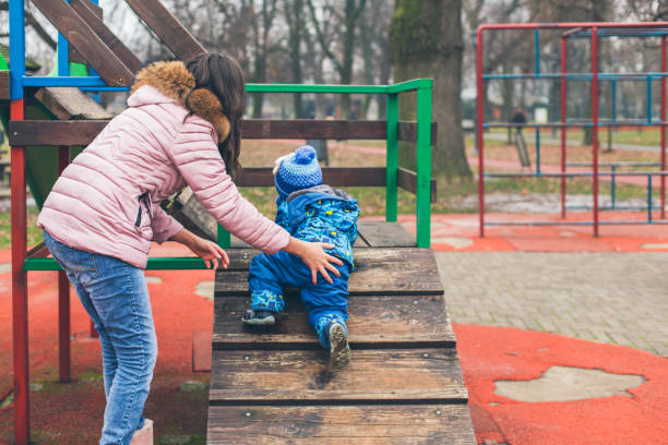 istock Mother helping her little son 921367872